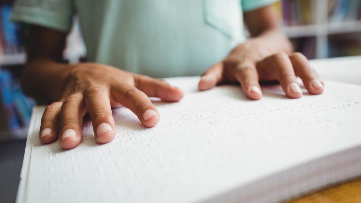 A photo of a child reading braille